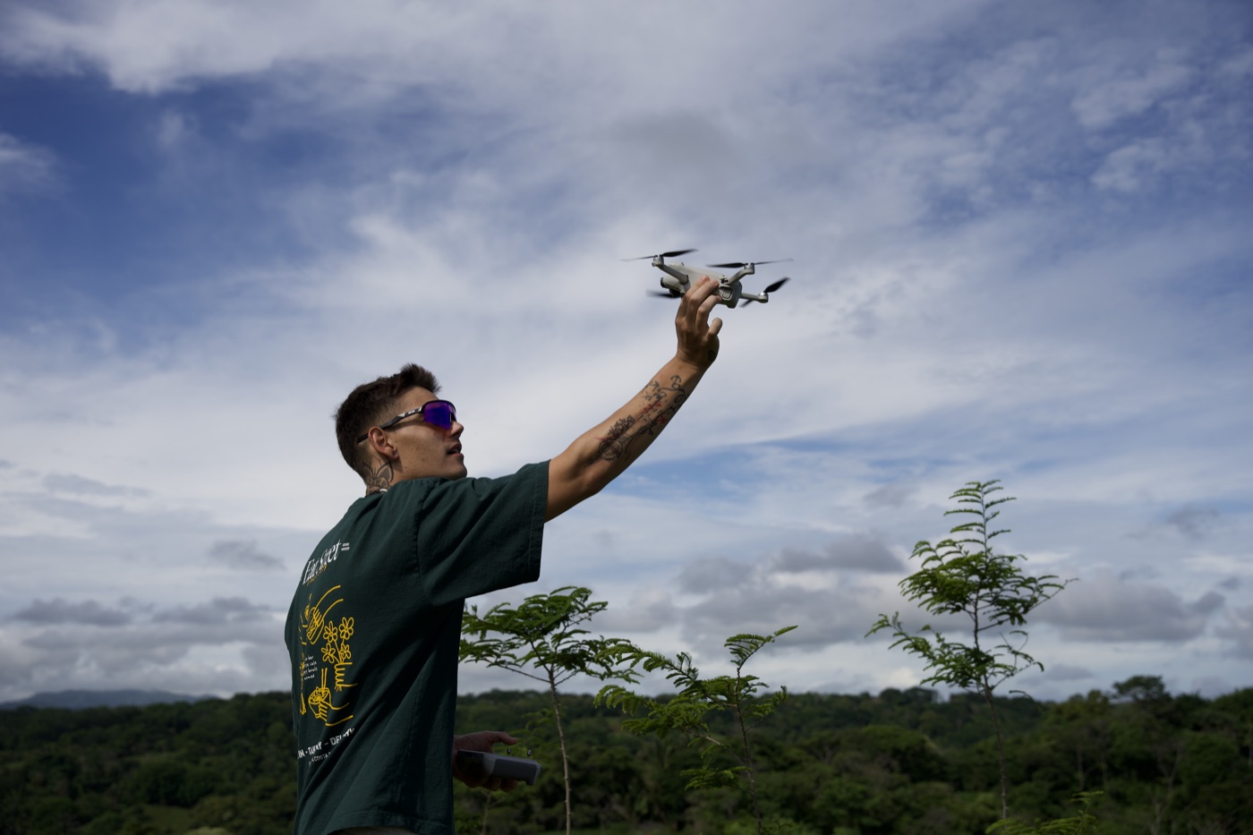 Pascal Reimann flying a drone over the treeline